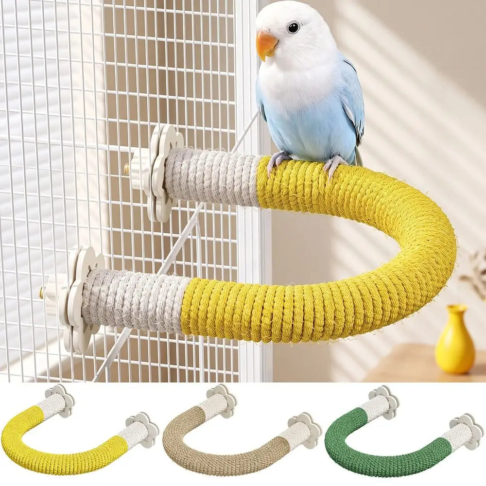 A small blue-and-white bird perched on a curved rope bird perch mounted on a wire cage. The perch has a yellow and off-white rope wrap with white plastic mounting hardware.