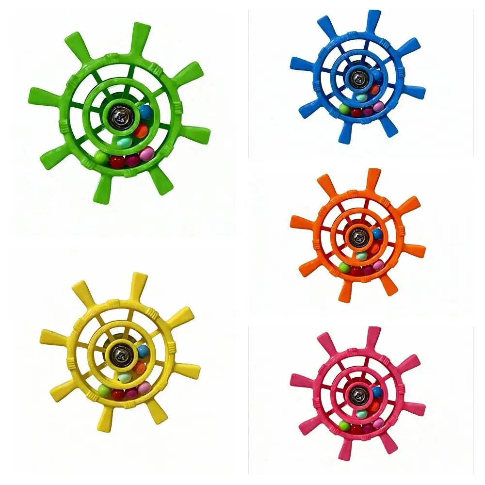 Four ship's wheel-shaped baby teething toys in green, blue, orange, and pink, each with colorful beads inside, displayed on a white background.
