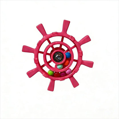 A pink ship's wheel fidget toy with colorful beads inside, shown on a plain white background.
