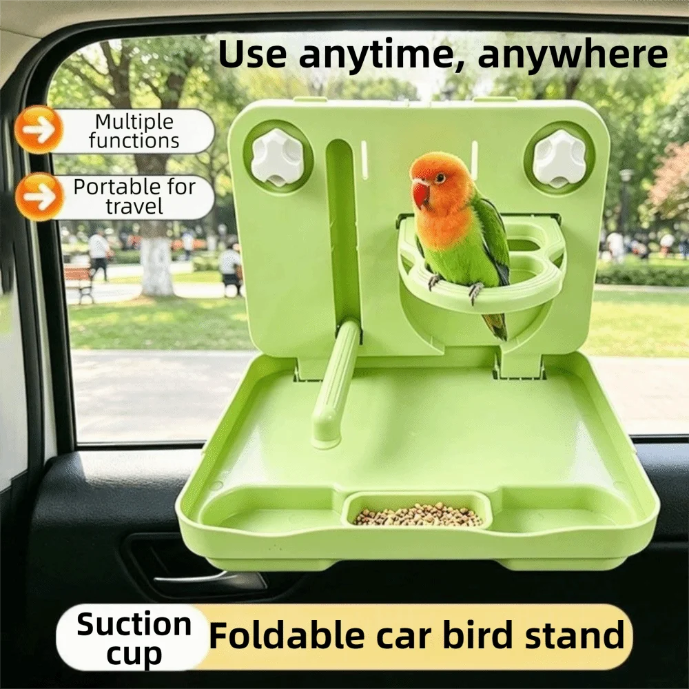 A light green foldable car bird stand with a suction cup attachment, shown mounted inside a car window. A small green and orange bird is perched on the stand, and birdseed is visible in the tray.