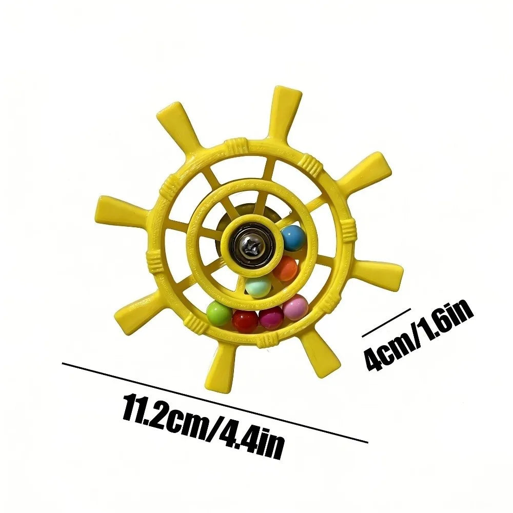 Yellow ship's wheel toy with colorful beads inside, shown with black dimension lines and text indicating 11.2cm/4.