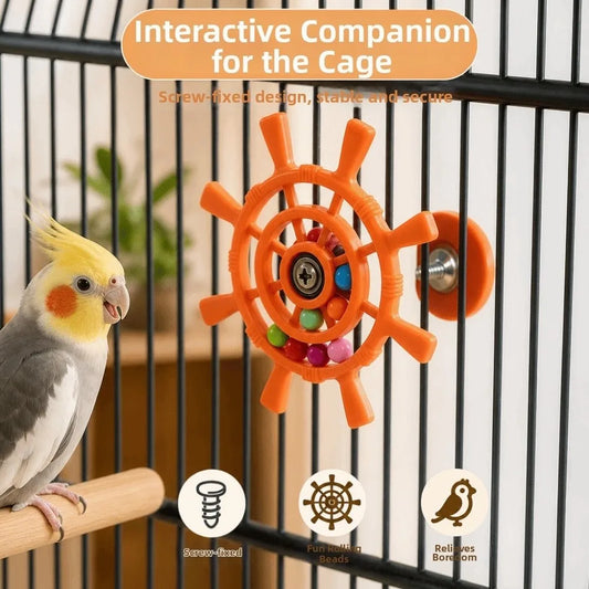 An orange screw-on bird cage toy with colorful beads and a central spinner wheel, mounted on a black metal cage. A yellow and gray cockatiel is perched on a wooden bar to the left.