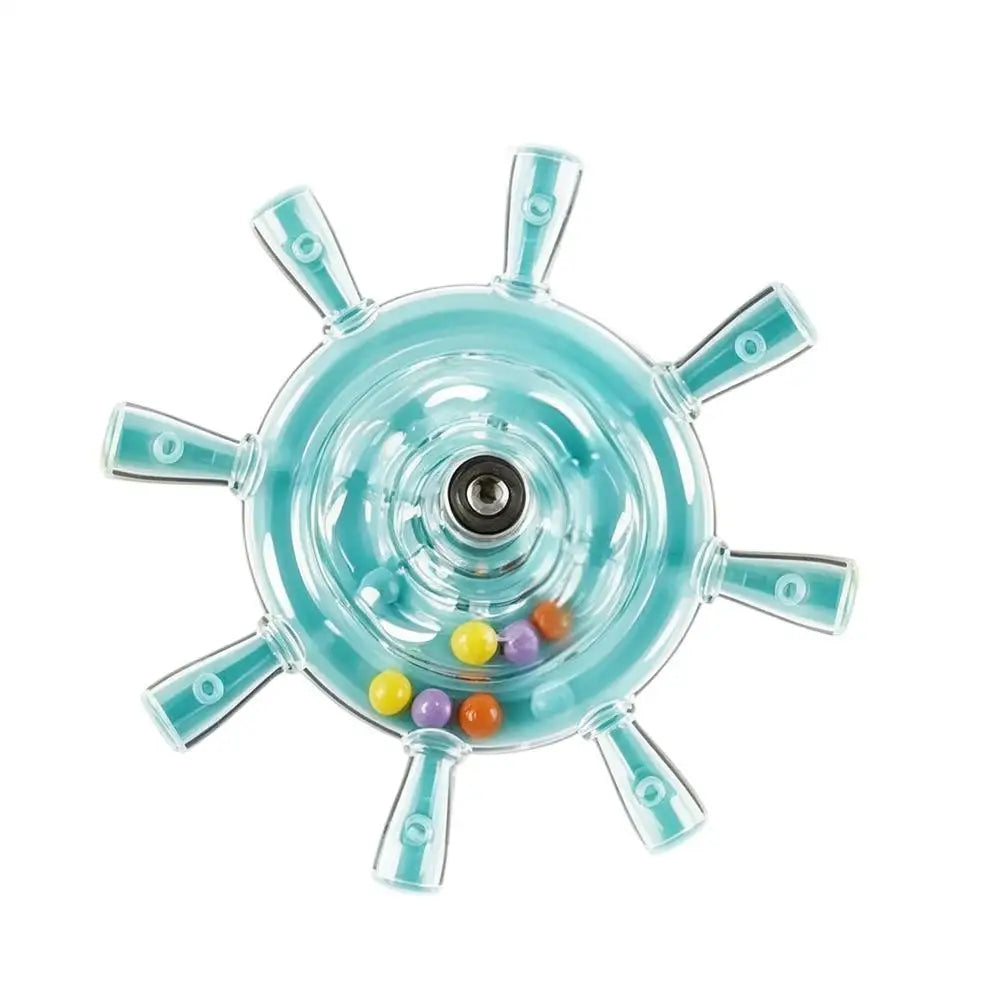 A clear plastic ship wheel toy with light blue accents and several small colorful beads inside, shown on a plain white background.