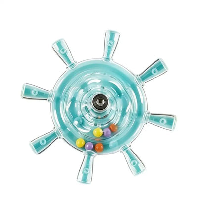 A clear plastic ship wheel toy with light blue accents and several small colorful beads inside, shown on a plain white background.